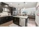 Modern kitchen with dark cabinetry, stainless steel appliances and island at 2508 Rambling Creek Rd, Apex, NC 27523