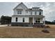 Charming two-story home with a stone-accented facade and inviting covered porch at 266 Weddington Way, Benson, NC 27504