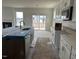 Open concept kitchen with stainless steel appliances and center island overlooking living area at 266 Weddington Way, Benson, NC 27504