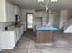 Open concept kitchen with center island and white cabinetry offering abundant storage at 266 Weddington Way, Benson, NC 27504