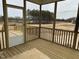 Screened porch with natural wood flooring offering views of the spacious back yard at 266 Weddington Way, Benson, NC 27504