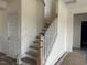 A staircase with a wooden handrail and white banisters at 266 Weddington Way, Benson, NC 27504