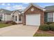 Attached garage with white door and brick exterior at 3009 Old Craig Trl, Mebane, NC 27302