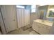 Bright bathroom features a shower-tub combo with white shower curtain and modern vanity at 317 Everly Mist Way, Wake Forest, NC 27587