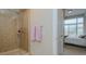 Bathroom with shower and view into bedroom at 400 W North St # 820, Raleigh, NC 27603