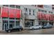 Modern building exterior with red awnings and ample street parking at 400 W North St # 820, Raleigh, NC 27603