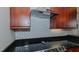 Modern kitchen with stainless steel appliances and dark granite countertops at 400 W North St # 820, Raleigh, NC 27603