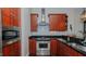 Modern kitchen with stainless steel appliances and dark granite countertops at 400 W North St # 820, Raleigh, NC 27603