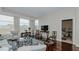 Open living room with hardwood floors, a view into the bedroom, and comfortable furniture at 400 W North St # 820, Raleigh, NC 27603