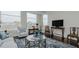 Living room with hardwood floors, comfortable seating, large windows, and city views at 400 W North St # 820, Raleigh, NC 27603