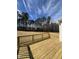 This wooden deck has a wood fence overlooking the backyard and line of trees in the distance at 427 Rising Star Dr, Clayton, NC 27520