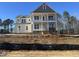 Two-story house with beige siding, a front porch, and a brick facade at 427 Rising Star Dr, Clayton, NC 27520