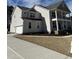 Side view of a two-story home with a two-car garage and manicured lawn at 427 Rising Star Dr, Clayton, NC 27520