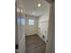 A neutral laundry room with plank floors and a window for natural light at 427 Rising Star Dr, Clayton, NC 27520