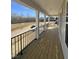 This is a wooden porch with a black metal fence and wooden columns at 427 Rising Star Dr, Clayton, NC 27520