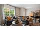 Spacious living room with sectional sofa, large window, and adjacent dining area at 442 Belgian Red Way, Wake Forest, NC 27587