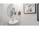 Chic powder room with an oval mirror and modern vanity at 442 Belgian Red Way, Wake Forest, NC 27587