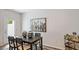 Dining area with dark wood table and modern art at 444 Belgian Red Way, Wake Forest, NC 27587