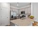 Modern kitchen with stainless steel appliances and granite countertops at 444 Belgian Red Way, Wake Forest, NC 27587