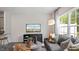 Spacious living room features a comfortable sectional sofa and large windows at 444 Belgian Red Way, Wake Forest, NC 27587