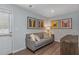 Finished basement with gray sofa and framed artwork at 4505 Black Drum Dr, Raleigh, NC 27616