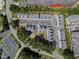 An aerial view shows the Durant Station community with its townhomes, parking, pond, and green spaces at 4821 Gossamer Ln # 106, Raleigh, NC 27616