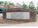 The Durant Station sign is made of brick and features a silver panel with the community name at 4821 Gossamer Ln # 106, Raleigh, NC 27616