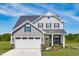 Two-story house with gray siding, white garage door, and landscaping at 508 Freedom Trail Dr, Angier, NC 27592