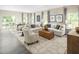 Relaxing living room with light beige sofas and a leather ottoman at 508 Freedom Trail Dr, Willow Springs, NC 27592