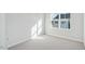 Bright bedroom with a large window and neutral carpet; a simple, clean aesthetic at 602 Hillfarm Dr, Wake Forest, NC 27587