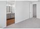 Bedroom showcasing an open doorway to the bathroom, with neutral carpet and light walls at 602 Hillfarm Dr, Wake Forest, NC 27587