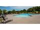 Large community pool with ample seating and umbrella covered tables for residents to enjoy at 602 Hillfarm Dr, Wake Forest, NC 27587