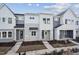 New construction townhomes featuring gray and white siding, covered entries, and well manicured landscaping at 602 Hillfarm Dr, Wake Forest, NC 27587