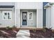 Townhouse entrance with dark gray door and porch at 602 Hillfarm Dr, Wake Forest, NC 27587