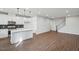Open-concept kitchen features a center island, modern appliances, tile backsplash, and opens to the living area at 602 Hillfarm Dr, Wake Forest, NC 27587