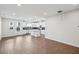 Spacious open-concept living space with wood flooring and bright natural light, connecting to the kitchen at 602 Hillfarm Dr, Wake Forest, NC 27587
