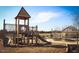 Community playground featuring a tower, slide, and climbing structure, creating a fun and safe environment for children at 602 Hillfarm Dr, Wake Forest, NC 27587