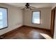 Bright bedroom featuring hardwood floors and a ceiling fan at 605 E Montgomery St, Henderson, NC 27536