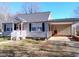 Gray siding house with carport and red door at 618 N Third St, Mebane, NC 27302