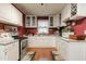 Bright kitchen features white cabinets, stainless steel appliances, and granite countertops at 6238 Old 421 Rd, Liberty, NC 27298