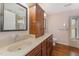 Double vanity bathroom with a large mirror and wood cabinets at 6301 King Lawrence Rd, Raleigh, NC 27607