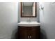 Small bathroom with pedestal sink and patterned wallpaper at 6409 New Market Way, Raleigh, NC 27615