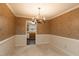 Dining room with a chandelier and patterned wallpaper at 6409 New Market Way, Raleigh, NC 27615