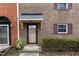 Townhouse entryway with brick exterior and shrubs at 6409 New Market Way, Raleigh, NC 27615