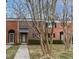 Brick townhouse exterior with landscaping and walkway at 6409 New Market Way, Raleigh, NC 27615