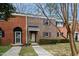 Front view of a brick townhouse with landscaping at 6409 New Market Way, Raleigh, NC 27615