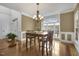 Bright dining room with hardwood floors, chandelier, and large windows at 7400 Duncans Ridge Way, Fuquay Varina, NC 27526