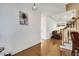 Bright hallway with hardwood floors and a view into the living room at 7400 Duncans Ridge Way, Fuquay Varina, NC 27526