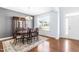 Formal dining room with hardwood floors, a chandelier, and a wooden table at 8065 Gilano Dr, Raleigh, NC 27603