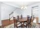 Formal dining room with hardwood floors, a chandelier, and a wooden table at 8065 Gilano Dr, Raleigh, NC 27603